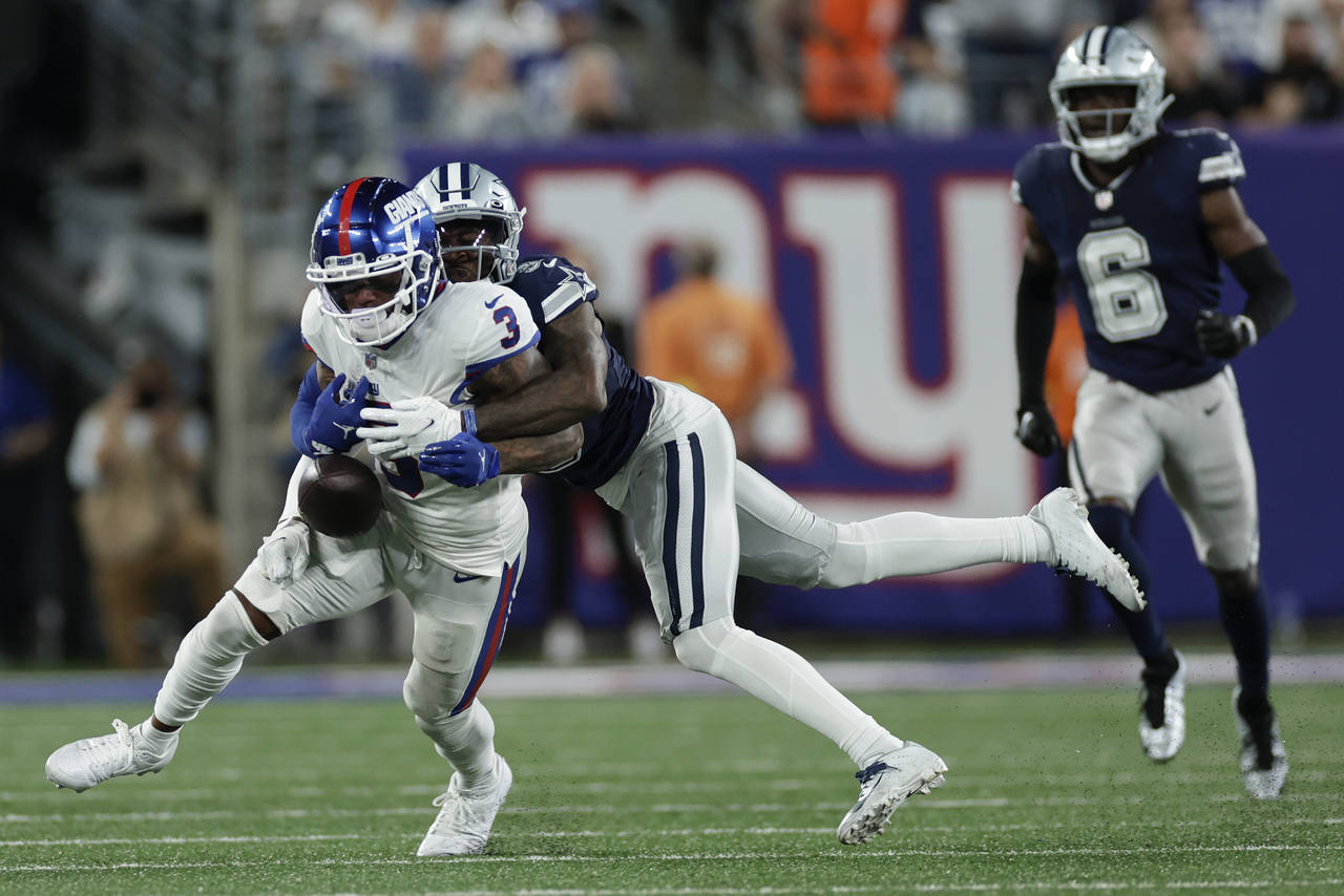 Dallas Cowboys cornerback Anthony Brown (3) strips the ball from New York Giants wide receiver Ster...