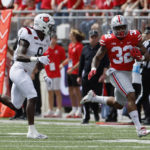 
              Ohio State running back TreVeyon Henderson, right, turns up field against Arkansas State defensive back Eddie Smith during the first half of an NCAA college football game Saturday, Sept. 10, 2022, in Columbus, Ohio. (AP Photo/Jay LaPrete)
            
