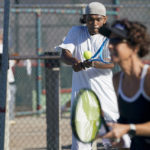 
              James Duff, an inmate at San Quentin State Prison, hits a return while playing tennis alongside Associated Press sports reporter Janie McCauley, foreground, in San Quentin, Calif., Saturday, Aug. 13, 2022. (AP Photo/Godofredo A. Vásquez)
            