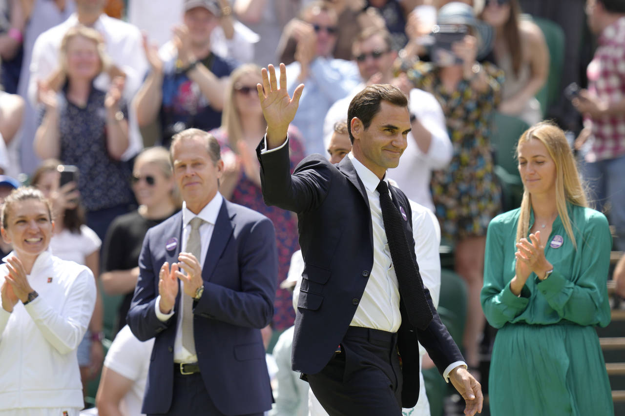FILE - Switzerland's Roger Federer waves during a 100 years of Centre Court celebration on day seve...