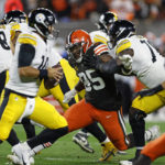 
              Cleveland Browns defensive end Myles Garrett (95) rushes Pittsburgh Steelers quarterback Mitch Trubisky (10) but can't get around James Daniels (78) during the first half of an NFL football game in Cleveland, Thursday, Sept. 22, 2022. (AP Photo/Ron Schwane)
            