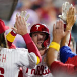 
              Philadelphia Phillies' Rhys Hoskins celebrates with teammates after hitting a home run against Washington Nationals pitcher Patrick Corbin during the fourth inning of a baseball game, Friday, Sept. 9, 2022, in Philadelphia. (AP Photo/Matt Slocum)
            