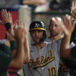 
              Oakland Athletics' Chad Pinder (10) celebrates in the dugout after scoring off of a single hit by Cristian Pache during the second inning of a baseball game against the Los Angeles Angels in Anaheim, Calif., Tuesday, Sept. 27, 2022. (AP Photo/Ashley Landis)
            