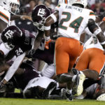
              Texas A&M running back LJ Johnson Jr. (34) dives over the pile to score a touchdown against Miami during the first quarter of an NCAA college football game Saturday, Sept. 17, 2022, in College Station, Texas. (AP Photo/Sam Craft)
            