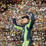 
              Erik Jones celebrates in the Winner's Circle after the NASCAR Southern 500 auto race Sunday, Sept. 4, 2022, in Darlington, S.C. Jones held on to the victory after taking the lead from Kyle Busch, who blew a motor with 30 laps remaining. (AP Photo/Sean Rayford)
            