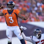 
              Denver Broncos quarterback Russell Wilson (3) is pressured by Houston Texans defensive end Jonathan Greenard (52) during the second half of an NFL football game, Sunday, Sept. 18, 2022, in Denver. (AP Photo/David Zalubowski)
            