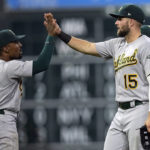 
              Oakland Athletics' Seth Brown (15) celebrates with Tony Kemp (5) after a baseball game against the Houston Astros Saturday, Sept. 17, 2022, in Houston. The Athletics won 8-5. (AP Photo/David J. Phillip)
            