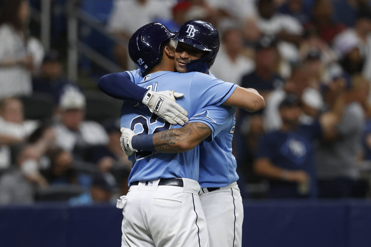 Tampa Bay Rays' Christian Bethancourt, right, embraces teammate Jose Siri after hitting a two-run h...