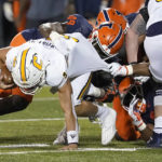 
              Illinois' Seth Coleman (49) and Jer'Zhan Newton sack Chattanooga quarterback Preston Hutchinson during the second half of an NCAA college football game Thursday, Sept. 22, 2022, in Champaign, Ill. (AP Photo/Charles Rex Arbogast)
            