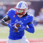 
              SMU wide receiver Rashee Rice looks to run after catching a pass during the first half of an NCAA college game against TCU on Saturday, Sept. 24, 2022, in Dallas, Texas. (AP Photo/Gareth Patterson)
            