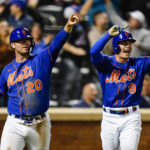 
              New York Mets' Pete Alonso (20) and Brandon Nimmo (9) gesture to Eduardo Escobar after they scored on a two-run single by Escobar during the eighth inning of a baseball game against the Miami Marlins Wednesday, Sept. 28, 2022, in New York. (AP Photo/Frank Franklin II)
            
