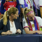 
              Cindy Parlow Cone, left, president of the U.S. Soccer Federation, looks on as United States' Becky Sauerbrunn signs a new collective bargaining agreement as part of an event in which with the federation, U.S. Women's National Team Players Association and the U.S. National Soccer Team Players Association signed new collective bargaining agreements following the women's match against Nigeria at Audi Field, Tuesday, Sept. 6, 2022, in Washington. The U.S. won 2-1. (AP Photo/Julio Cortez)
            