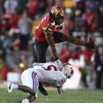 
              Maryland safety Beau Brade, top, intercepts a pass and is tackled by SMU's Moochie Dixon in the first half of an NCAA college football game, Saturday, Sept. 17, 2022, in College Park, Md. (AP Photo/Gail Burton)
            