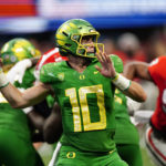 
              Oregon quarterback Bo Nix (10) throws from the pocket in the second half of an NCAA college football game against Georgia, Saturday, Sept. 3, 2022, in Atlanta. (AP Photo/John Bazemore)
            