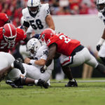 
              Samford quarterback Michael Hiers (10) is stopped by Georgia defenders Tramel Walthour (90), Nazir Stackhouse (78), and Robert Beal Jr. (33) during the first half of an NCAA college football game, Saturday, Sept. 10, 2022 in Athens, Ga. (AP Photo/John Bazemore)
            