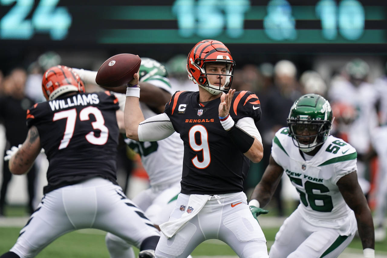 Cincinnati Bengals quarterback Joe Burrow looks to throw a pass during the first half of an NFL foo...