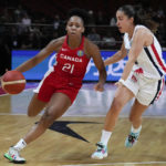 
              Canada's Nirra Fields, left, runs past France's Marine Fauthoux during their game at the women's Basketball World Cup in Sydney, Australia, Friday, Sept. 23, 2022. (AP Photo/Mark Baker)
            