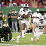 
              BYU running back Christopher Brooks (2) runs for a 52-yard touchdown during the second half of the team's NCAA college football game against South Florida on Saturday, Sept. 3, 2022, in Tampa, Fla. (AP Photo/Jason Behnken)
            