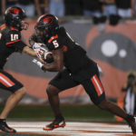 
              Oregon State quarterback Chance Nolan (10) hands off to running back Deshaun Fenwick (5) during the first half of the team's NCAA college football game against Boise State on Saturday, Sept. 3, 2022, in Corvallis, Ore. (AP Photo/Amanda Loman)
            