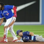 
              Toronto Blue Jays' Vladimir Guerrero Jr., left, celebrates his double next to Tampa Bay Rays second baseman Jonathan Aranda during the sixth inning of the second baseball game of a doubleheader Tuesday, Sept. 13, 2022, in Toronto. (Frank Gunn/The Canadian Press via AP)
            