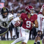 
              Alabama quarterback Bryce Young (9) works away from pressure from Vanderbilt linebacker Anfernee Orji (0) during the second half of an NCAA college football game Saturday, Sept. 24, 2022, in Tuscaloosa, Ala. (AP Photo/Vasha Hunt)
            