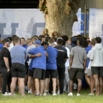 
              Indiana State football assistant head coach Mark Smith hugs a player after a vigil on Sunday, Aug. 21, 2022 at Memorial Stadium in Terre Haute, Ind., for students, including fellow football players, who were involved in a car crash earlier in the day. (Joseph C. Garza/The Tribune-Star via AP)
            
