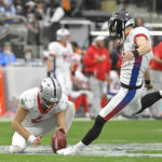 
              FILE - AFC kicker Justin Tucker of the Baltimore Ravens, right, makes a point-after as AFC punter AJ Cole (6), of the Las Vegas Raiders, holds during the first half of the Pro Bowl NFL football game against the NFC, Sunday, Feb. 6, 2022, in Las Vegas.  The NFL is replacing the Pro Bowl with weeklong skills competitions and a flag football game. The new event will be renamed “The Pro Bowl Games” and will feature AFC and NFC players showcasing their football and non-football skills in challenges over several days.   (AP Photo/David Becker, File)
            
