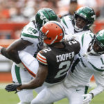 
              Cleveland Browns wide receiver Amari Cooper (2) is upended by New York Jets cornerback Sauce Gardner (1), linebacker Quincy Williams (56), and safety Jordan Whitehead (3) after making a catch during the first half of an NFL football game, Sunday, Sept. 18, 2022, in Cleveland. (AP Photo/Ron Schwane)
            