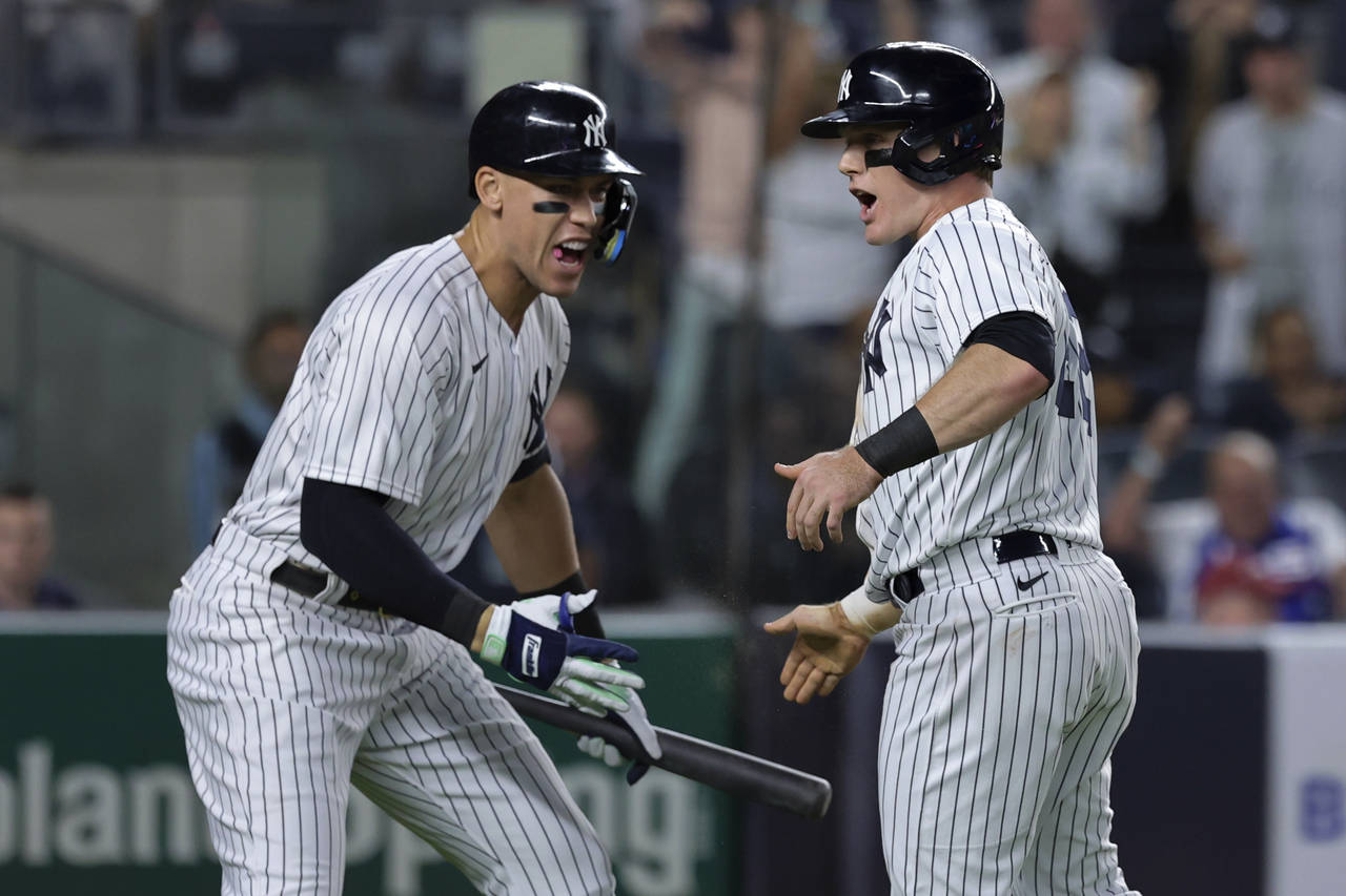 New York Yankees' Harrison Bader celebrates Aaron Judge after scoring against the Pittsburgh Pirate...