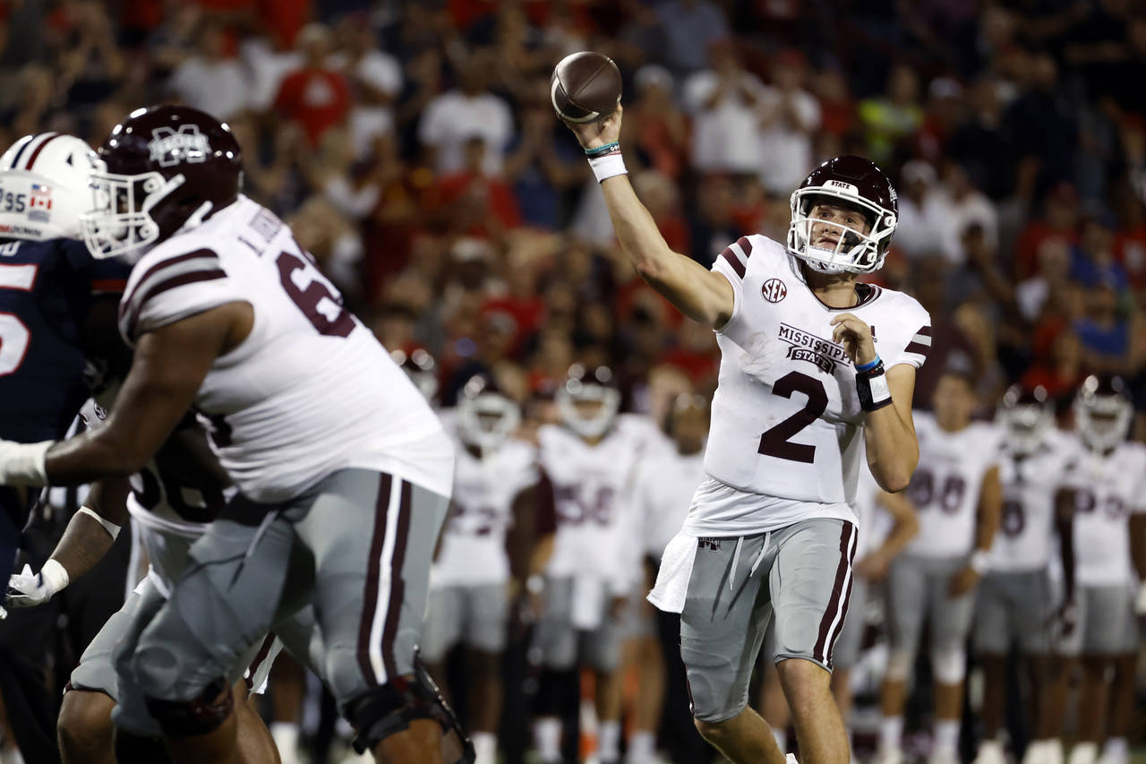 Mississippi State quarterback Will Rogers throws a touchdown in the second half against Arizona dur...
