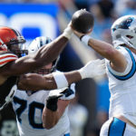 
              Carolina Panthers quarterback Baker Mayfield passes under pressure from Cleveland Browns defensive end Myles Garrett during the second half of an NFL football game on Sunday, Sept. 11, 2022, in Charlotte, N.C. (AP Photo/Rusty Jones)
            