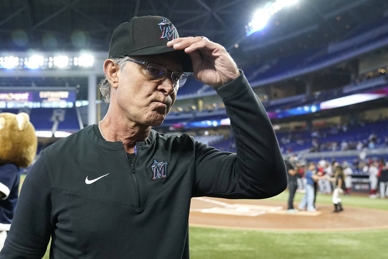 Miami Marlins manager Don Mattingly walks to the dugout before a baseball game against the Washingt...