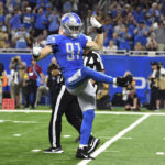 
              Detroit Lions defensive end Aidan Hutchinson (97) celebrates after sacking Washington Commanders quarterback Carson Wentz (11) during the first half of an NFL football game Sunday, Sept. 18, 2022, in Detroit. (AP Photo/Lon Horwedel)
            