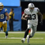 
              Las Vegas Raiders tight end Darren Waller (83) runs in front of Los Angeles Chargers linebacker Drue Tranquill (49) during the second half of an NFL football game in Inglewood, Calif., Sunday, Sept. 11, 2022. (AP Photo/Gregory Bull)
            