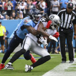 
              Las Vegas Raiders wide receiver Davante Adams (17) catches a touchdown pass as Tennessee Titans safety Kevin Byard (31) hangs on in the first half of an NFL football game Sunday, Sept. 25, 2022, in Nashville, Tenn. (AP Photo/John Amis)
            