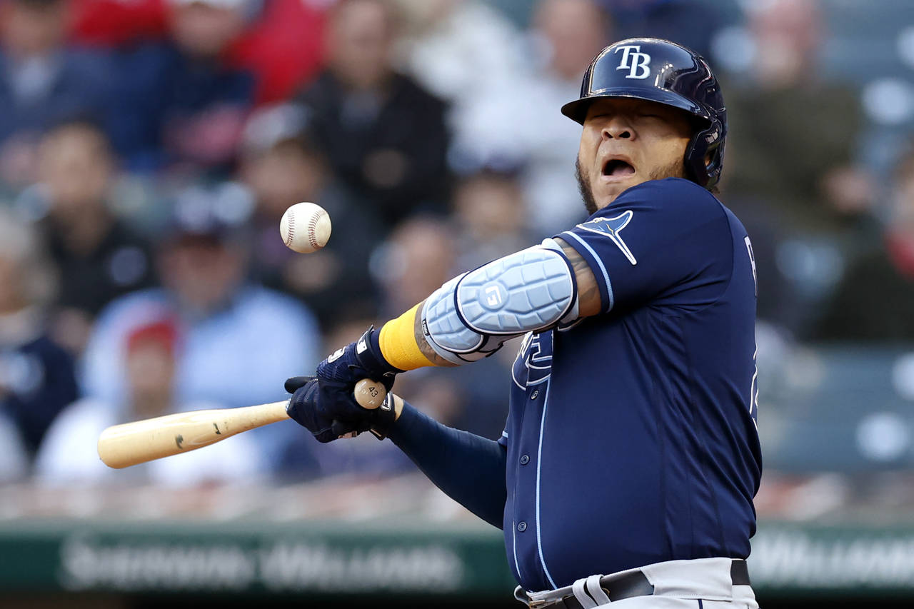 Tampa Bay Rays' Harold Ramirez reacts after being hit by a pitch from Cleveland Guardians starter C...