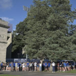 
              People gather near the entrance to Memorial Stadium, home of the Indiana State Sycamores NCAA college football team, during a vigil for victims of a car crash in Terre Haute, Ind., Aug. 21, 2022.   (Joseph C. Garza/The Tribune-Star via AP)
            