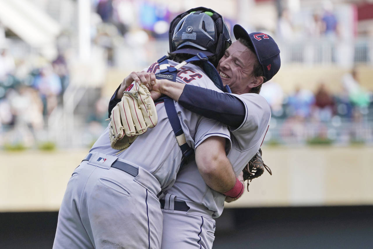 Cleveland Guardians pitcher James Karinchak, right, and catcher Austin Hedges celebrate after they ...