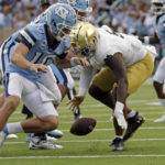 
              North Carolina quarterback Drake Maye (10) fumbles the ball and Notre Dame defensive lineman Justin Ademilola (9), right, recovers it during the second half of an NCAA college football game in Chapel Hill, N.C., Saturday, Sept. 24, 2022. (AP Photo/Chris Seward)
            