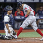 
              Boston Red Sox's Tommy Pham scores in front of Tampa Bay Rays catcher Francisco Mejia on his two-run home run during the eighth inning of a baseball game Tuesday, Sept. 6, 2022, in St. Petersburg, Fla. (AP Photo/Mike Carlson)
            