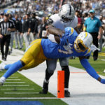 
              Los Angeles Chargers tight end Gerald Everett, bottom, scores a touchdown against Las Vegas Raiders safety Roderic Teamer during the second half of an NFL football game in Inglewood, Calif., Sunday, Sept. 11, 2022. (AP Photo/Gregory Bull)
            