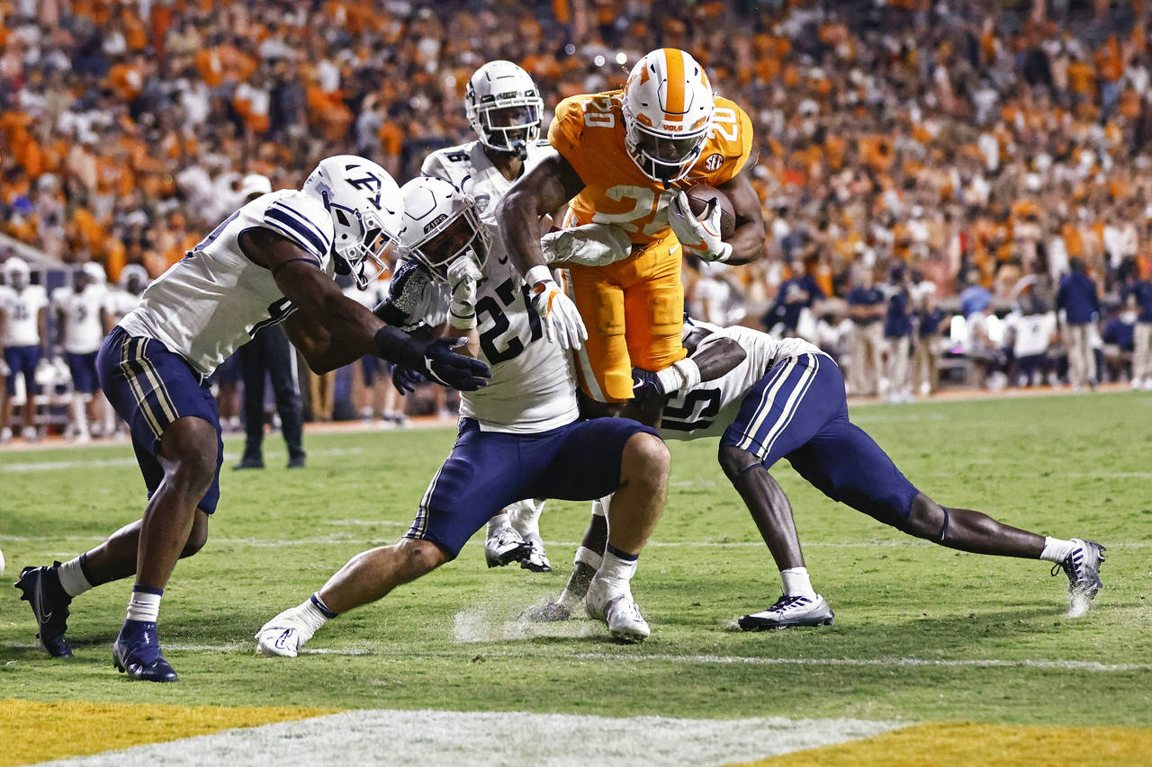Tennessee running back Jaylen Wright (20) leaps for the end zone as he's tackled by Akron linebacke...