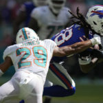 
              Miami Dolphins safety Brandon Jones (29) grabs Buffalo Bills running back James Cook (28) during the second half of an NFL football game, Sunday, Sept. 25, 2022, in Miami Gardens, Fla. (AP Photo/Rebecca Blackwell)
            