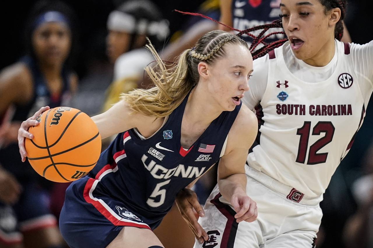 FILE - UConn's Paige Bueckers tries to get past South Carolina's Brea Beal during the Women's Final...