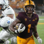 
              Arizona State running back Xazavian Valladay (1) scores a touchdown against Northern Arizona during the first half during an NCAA college football game Thursday, Sept. 1, 2022, in Tempe, Ariz. (AP Photo/Rick Scuteri)
            