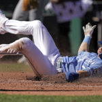 
              Kansas City Royals' Bobby Witt Jr. slides home to score on a double by Vinnie Pasquantino during the third inning of a baseball game against the Seattle Mariners Sunday, Sept. 25, 2022, in Kansas City, Mo. (AP Photo/Charlie Riedel)
            