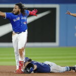 
              Toronto Blue Jays' Vladimir Guerrero Jr., left, celebrates his double next to Tampa Bay Rays second baseman Jonathan Aranda during the sixth inning of the second baseball game of a doubleheader Tuesday, Sept. 13, 2022, in Toronto. (Frank Gunn/The Canadian Press via AP)
            