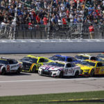 
              Racers head down the front straightaway during a restart at a NASCAR Cup Series auto race at Kansas Speedway in Kansas City, Kan., Sunday, Sept. 11, 2022. (AP Photo/Colin E. Braley)
            