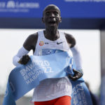 
              Kenya's Eliud Kipchoge crosses the line to win the Berlin Marathon in Berlin, Germany, Sunday, Sept. 25, 2022. Olympic champion Eliud Kipchoge has bettered his own world record in the Berlin Marathon. Kipchoge clocked 2:01:09 on Sunday to shave 30 seconds off his previous best-mark of 2:01:39 from the same course in 2018. (AP Photo/Christoph Soeder)
            