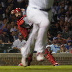 
              Cincinnati Reds catcher Austin Romine throws out Chicago Cubs' Yan Gomes at first during the sixth inning of a baseball game Tuesday, Sept. 6, 2022, in Chicago. (AP Photo/Charles Rex Arbogast)
            